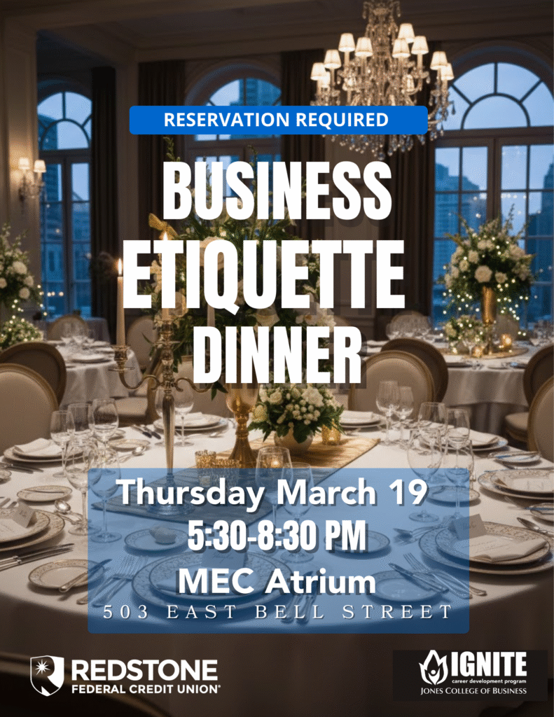 Formal setting dining tables with large floral arrangements in a room overlooking a city.